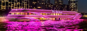 Luxury dinner cruise boat illuminated on Chao Phraya River at night in Bangkok Thailand