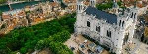 Aerial view of Basilica of Notre-Dame de Fourvière overlooking the Saône River and historic old town in Lyon