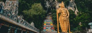 Batu Caves with colorful steps and giant golden Murugan statue Malaysia