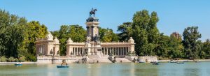Monument to Alfonso XII at El Retiro Park with rowing boats on the lake in Madrid