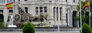 Cibeles Fountain with Spanish flags in Madrid city center