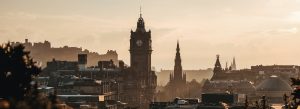 Sunset skyline of Edinburgh featuring Balmoral Hotel clock tower and the Scott Monument