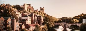 Sunset view of Durham with Durham Cathedral and Durham Castle overlooking the River Wear and historic bridge