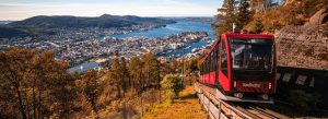 Fløibanen funicular ascending Mount Fløyen overlooking Bergen harbor, fjord, and cityscape in Norway