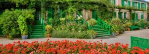 Foundation Claude Monet house with green shutters, surrounded by vibrant flower gardens in Giverny, France