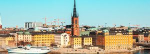 Colorful historic buildings of Gamla Stan along the waterfront in Stockholm on a sunny day