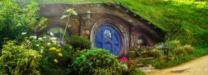 Hobbit hole with blue round door and lush garden at Hobbiton Movie Set in Matamata New Zealand