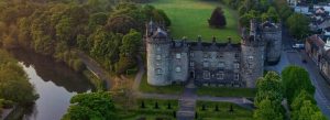 Kilkenny Castle beside the River Nore with lush gardens and historic town surroundings