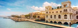 Macau Fisherman’s Wharf waterfront with colorful European-style buildings and marina along the harbor