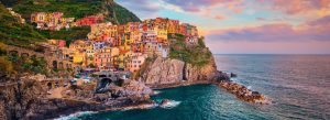 Colorful cliffside village of Manarola overlooking the Mediterranean Sea at sunset