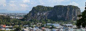 Limestone mountains rising above the city of Da Nang with lush greenery and urban houses below