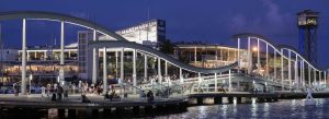 Maremagnum shopping center and Rambla de Mar pedestrian bridge at Port Vell Barcelona illuminated at night