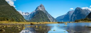 Scenic view of Milford Sound in Fiordland National Park, New Zealand with Mitre Peak, calm waters, and dramatic mountains