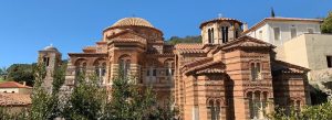 View of the Monastery of Hosios Loukas showcasing Byzantine domes, intricate brickwork, and historic architecture
