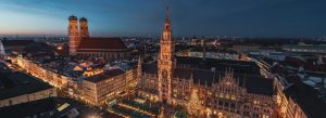 Aerial view of Marienplatz at dusk with the illuminated New Town Hall and Frauenkirche in Munich, Germany