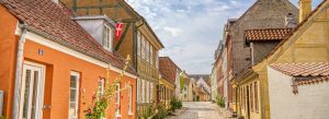 Colorful cobblestone street with historic houses in Ærøskøbing