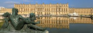 Panoramic view of the Palace of Versailles with the Latona Fountain in the foreground and its reflection in the Grand Canal.