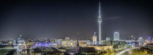 Night panorama of Berlin featuring Fernsehturm TV Tower, Berlin Cathedral, and illuminated city skyline