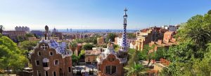 Colorful mosaic buildings in Park Güell overlooking the skyline of Barcelona, Spain