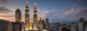 Petronas Twin Towers illuminated skyline Kuala Lumpur at dusk