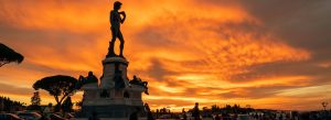 Replica of David by Michelangelo at Piazzale Michelangelo overlooking Florence at dramatic sunset with orange sky