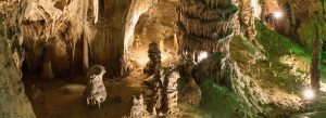 Illuminated stalactites and stalagmites inside Moravian Karst caves showcasing dramatic underground rock formations