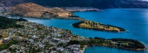 Aerial view of Queenstown and Lake Wakatipu in New Zealand with scenic mountains, blue waters, and lakeside town