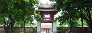 Temple of Literature entrance gate in Hanoi Vietnam surrounded by lush greenery and traditional architecture