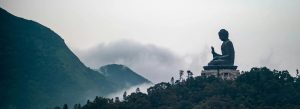 Tian Tan Buddha Lantau Island Hong Kong giant seated Buddha statue on hill with misty mountains backdrop