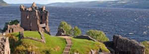 Urquhart Castle ruins overlooking Loch Ness with scenic Highland landscape