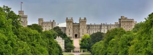 Long Walk leading to Windsor Castle surrounded by lush greenery under a cloudy sky