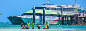 Snorkelers near a reef pontoon with a catamaran at Green Island on the Great Barrier Reef