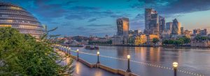 Twilight view of London skyline along the River Thames featuring City Hall and modern skyscrapers
