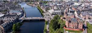 Aerial panorama of Inverness city center with the River Ness flowing through the Scottish Highlands