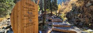 Wooden entrance sign and hiking trail at Almarasan Gorge near Almaty Kazakhstan