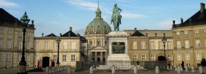 Amalienborg Palace courtyard in Copenhagen with the equestrian statue and Frederik’s Church dome in the background.