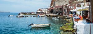 Traditional fishing boats and waterfront tavernas at Ammoudi Bay in Oia, Santorini, Greece