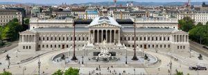 Austrian Parliament Building in Vienna, Austria, featuring grand neoclassical architecture, the Pallas Athena Fountain, and panoramic city views.