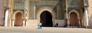 Intricate mosaic and horseshoe arches at Bab Mansour Gate in Meknes, Morocco, showcasing traditional Moroccan Islamic architecture.