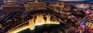 Aerial night view of the Bellagio Fountains and Las Vegas Strip skyline in Nevada with illuminated luxury hotels and casinos.