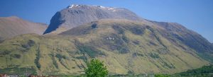 View of Ben Nevis mountain rising above the Scottish Highlands on a clear day.