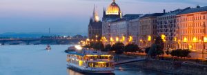 Evening boat cruise on the Danube River with illuminated Parliament building in Budapest, Hungary