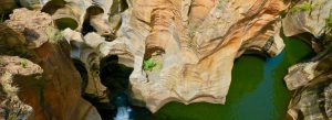 Natural rock formations and green water pools at Bourke’s Luck Potholes in Mpumalanga, South Africa.