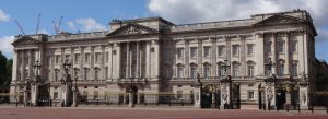 Front view of Buckingham Palace with ornate gates and royal architecture in London, England.
