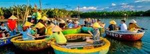 Tourists riding traditional basket boats at Cam Thanh Coconut Village near Hoi An, Vietnam
