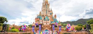 Castle of Magical Dreams at Hong Kong Disneyland with colorful decorations and Disney characters performing.