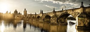 Historic Charles Bridge over the Vltava River at sunrise in Prague, Czech Republic.