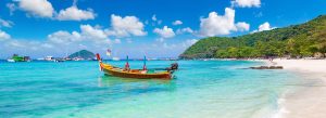 Traditional longtail boat on the turquoise waters of Coral Island near Pattaya, Thailand.