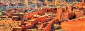 Traditional mud-brick village and kasbahs in Dadès Valley surrounded by the Atlas Mountains in Morocco.