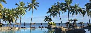 Beachfront resort in Fiji with infinity pool palm trees and ocean view